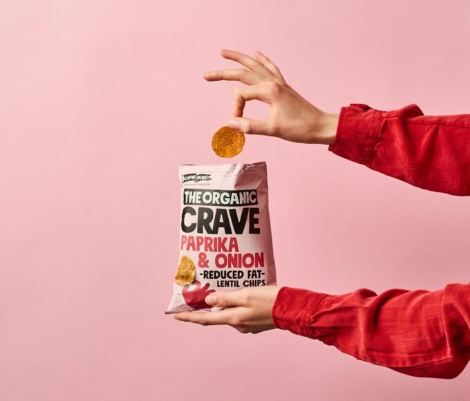 person holding white and red plastic pack