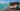 brown wooden bench on dock near body of water during daytime