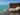 brown wooden bench on dock near body of water during daytime