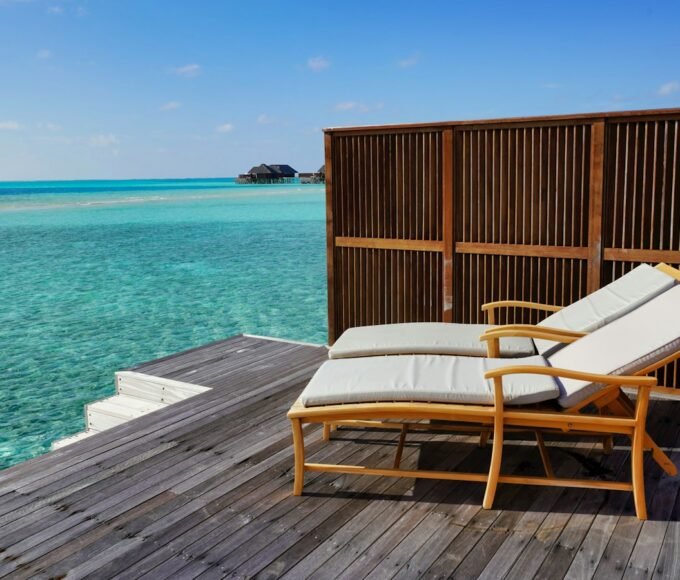 brown wooden bench on dock near body of water during daytime