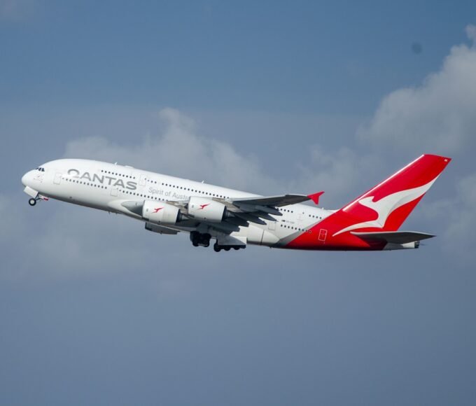 a large passenger jet flying through a cloudy blue sky