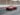 red coupe passing on road