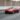 red coupe passing on road