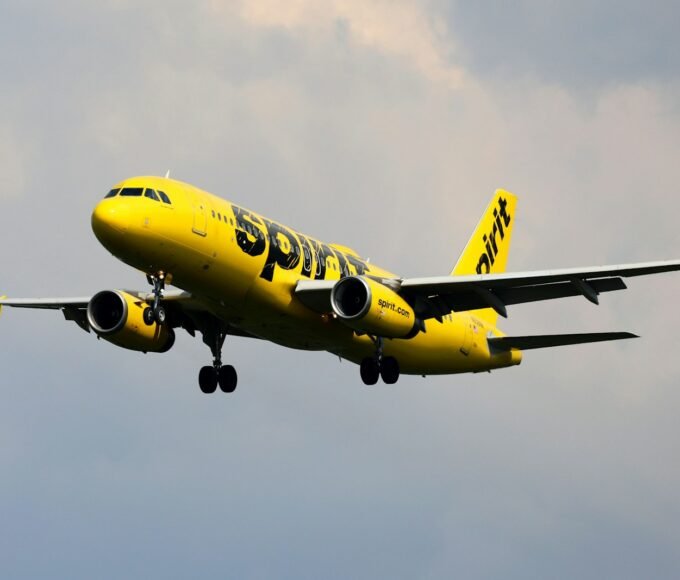 a yellow and black airplane flying