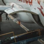 white plane releasing cargo