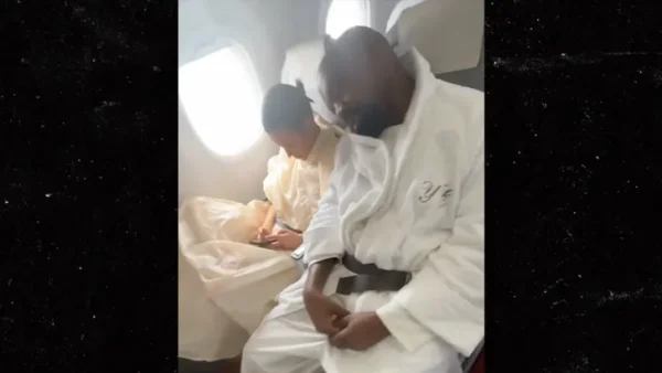 A picture of Kanye West flying coach.