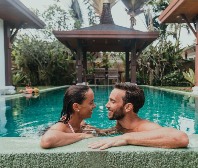 A couple sharing a loving moment in a resort.