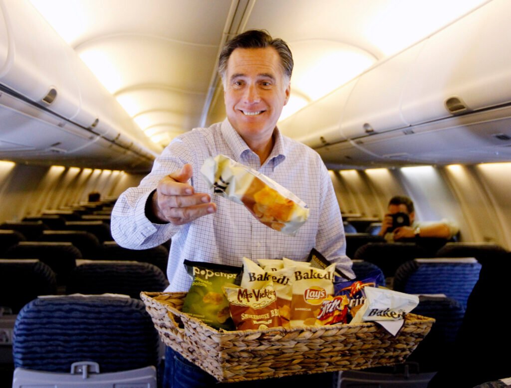 A picture of Mitt Romney handing out snacks in coach.