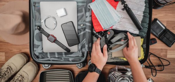 A traveler packing his bag without a smart tracker
